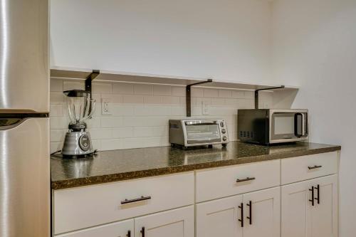 a kitchen counter with a microwave and a toaster oven at Riverfront Hideaway in Keene Walk to Town! in Keene