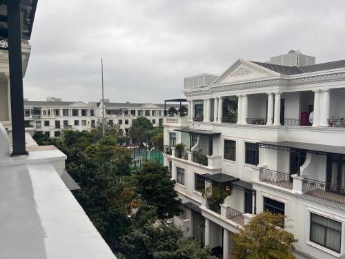 a white building with balconies and trees at HPT Home II Vinhome Marina chuỗi Apartment - Homestay in Hai Phong