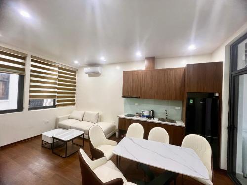 a kitchen and living room with a table and chairs at HPT Home II Vinhome Marina chuỗi Apartment - Homestay in Hai Phong