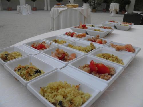 a table topped with trays of different types of food at Relais Fontevivo in Fontevivo