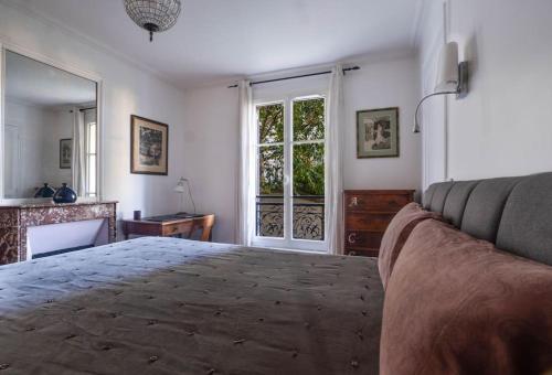 une chambre avec un lit, un canapé et une fenêtre dans l'établissement Charming flat in old Paris, à Paris