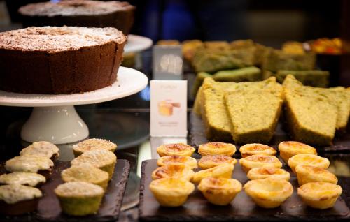 a display case with a chocolate cake and pastries at TURIM Saldanha Hotel in Lisbon