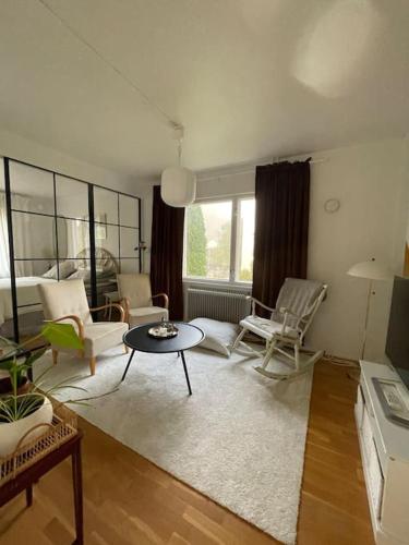 a living room with chairs and a table and a couch at 2 bedroom house central Parainen in Pargas