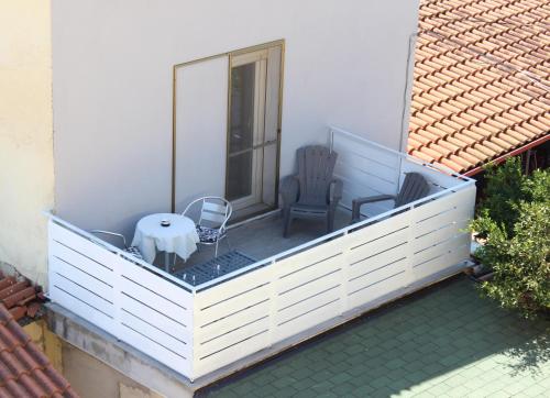a balcony with two chairs and a table on it at B&B La Vigna in Lamezia Terme