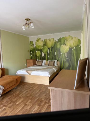 a bedroom with a bed with a flower mural on the wall at Gazelle 1 in Mykolaiv