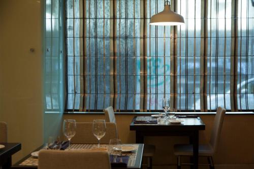 a dining room with a table and chairs and a window at TURIM Restauradores Hotel in Lisbon