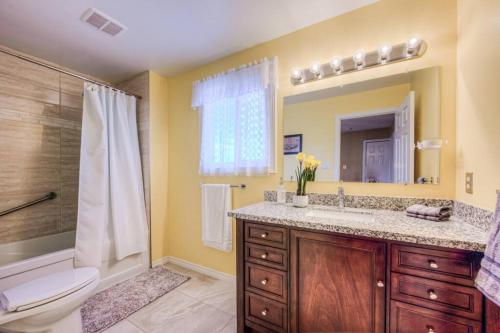 a bathroom with a toilet and a sink and a shower at 45 per Off Monthly Stay - 7 Beds - BBQ in Kitchener