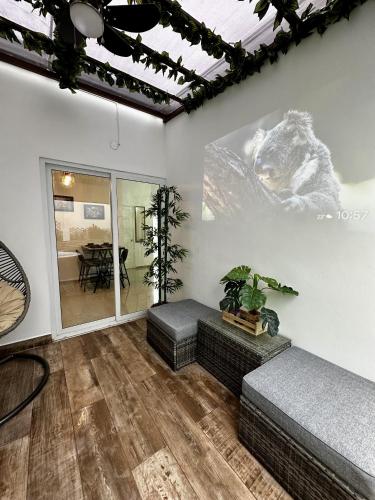 a living room with a couch and a table at Casa Los Ausoles con Jacuzzi in Ahuachapán