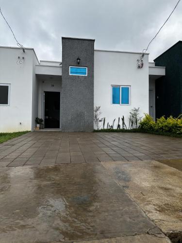 a white building with a blue sign on it at Casa Los Ausoles con Jacuzzi in Ahuachapán