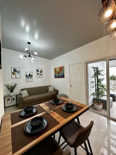 a living room with a table and a couch at Casa Los Ausoles con Jacuzzi in Ahuachapán