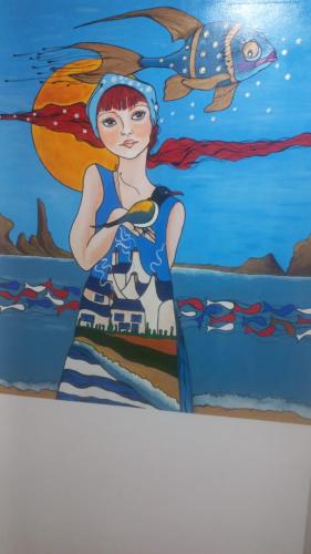 a painting of a woman standing in the ocean at Apartment Danubius in Donji Milanovac