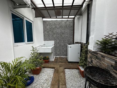 a patio with a white refrigerator in a building at Casa Los Ausoles con Jacuzzi in Ahuachapán