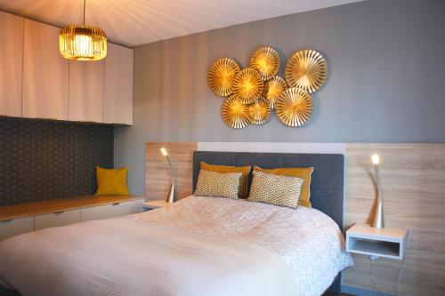 a bedroom with a large bed with yellow pillows at SweetHomeVersailles 10mn walk from Palace in Versailles