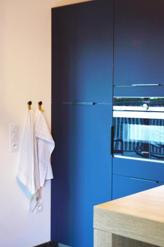 a blue refrigerator in a kitchen with a counter at SweetHomeVersailles 10mn walk from Palace in Versailles