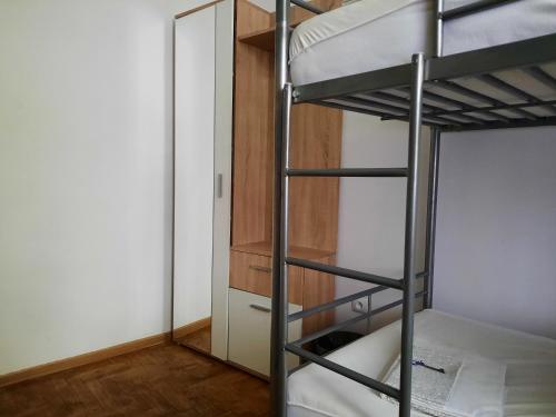 a bunk bed room with a ladder and a closet at Lorf Hostel&Coffee in Kraków