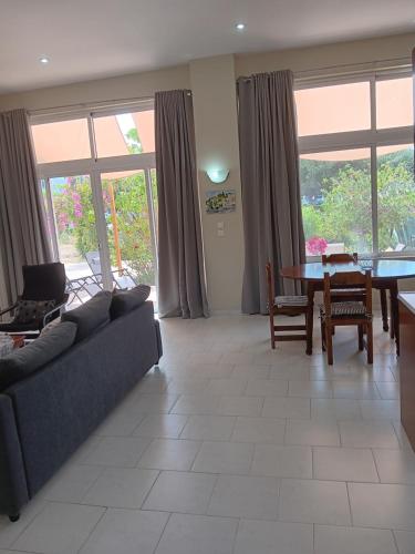 a living room with a couch and a table at Giulia's Beach House in Rhodes Town