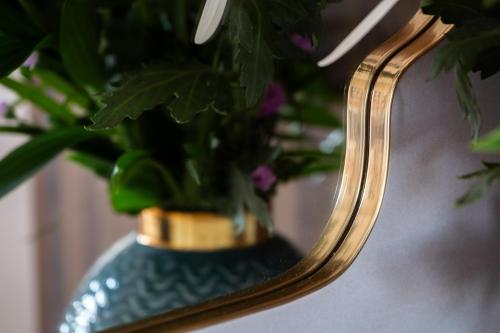 a blue vase with a plant in a mirror at Crown Street Aparthotel 2 in Halifax