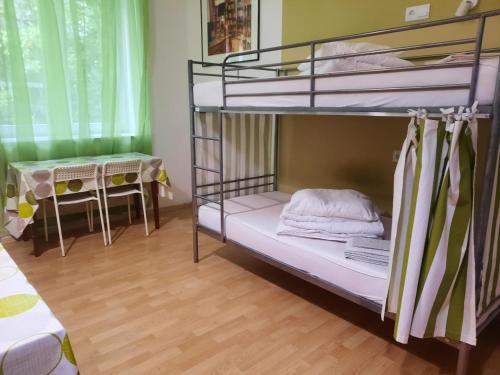 a bunk bed room with two bunk beds and a table at Lorf Hostel&Coffee in Kraków