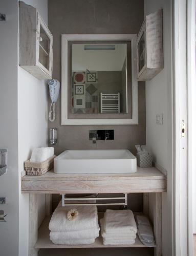 a bathroom with a sink and a mirror and towels at Primo Piano Suites in Rome
