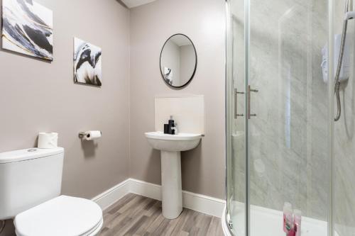 a bathroom with a toilet sink and a shower at Crown Street Aparthotel 2 in Halifax