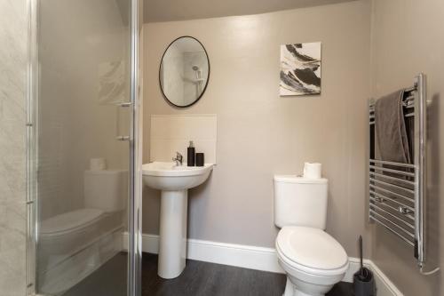 a bathroom with a toilet and a sink and a shower at Crown Street Aparthotel 2 in Halifax