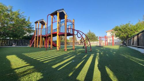a playground with a slide on the grass at Mythical Sands resort - Hana in Paralimni
