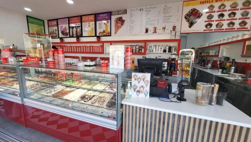 a food counter in a restaurant with a display case at Mythical Sands resort - Hana in Paralimni