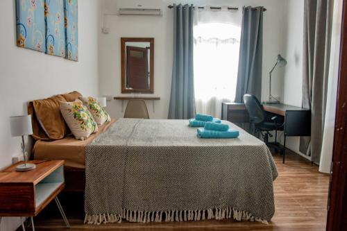 a living room with a bed and a couch at Nilaya Penthouse, 3BHK Luxury by Coastal in Roches Noires