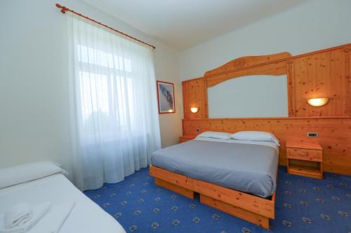 Ένα ή περισσότερα κρεβάτια σε δωμάτιο στο Hotel Regina del Bosco