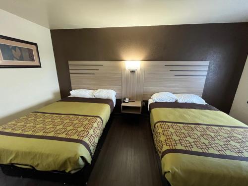 a room with two beds in a hotel room at Budget Inn By OYO Nassawadox Hwy 13 in Nassawadox