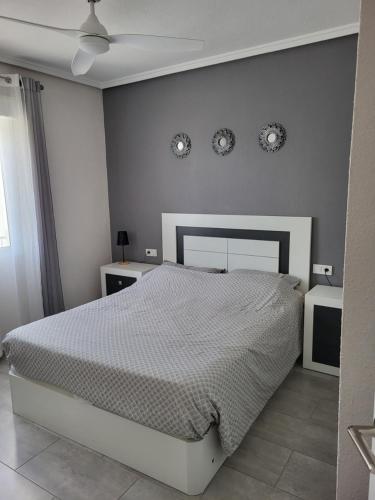 a bedroom with a bed and two clocks on the wall at Appartement Bella Vista in Rojales