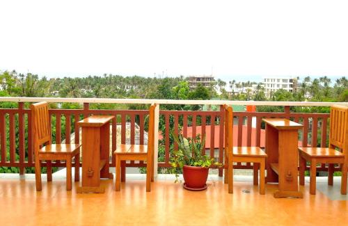 a deck with benches and a potted plant on it at Agos Boracay Rooms + Beds in Boracay