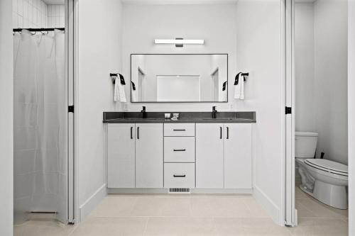 a white bathroom with a sink and a mirror at Golf and Ski Haven in Eden on Golf Course Pt C208 in Mountain View Estates