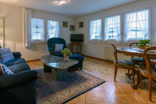 a living room with a couch and a table at Blattenheimat - im traditionellen Appenzeller Haus in Appenzell