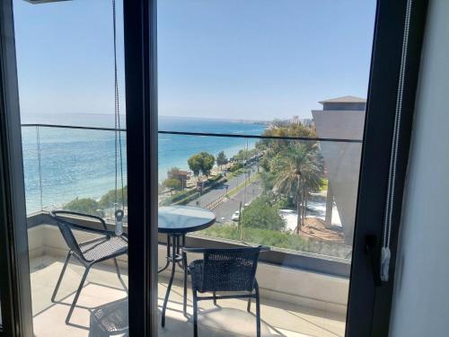 a balcony with a table and chairs and a view of the ocean at Seafront City Center Studio in Limassol