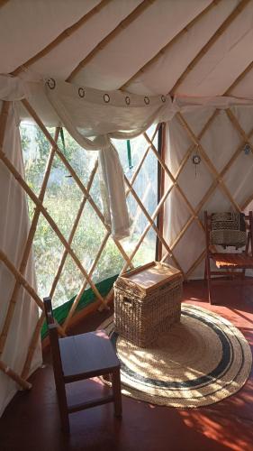 a room with a wicker basket in a yurt at Guardianas del Bosque in Playa Hermosa