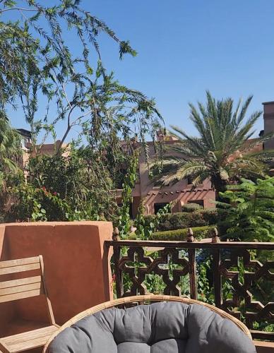 a wooden bench sitting on top of a balcony at Atlas golf in Marrakech