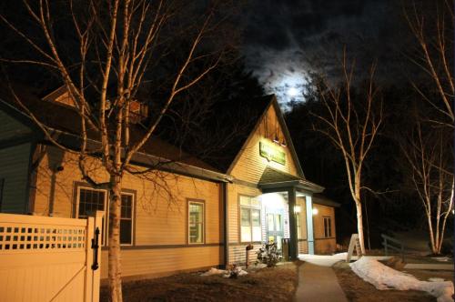 a house at night with the moon in the sky at Cold Spring Plymouth Resort in Ashland