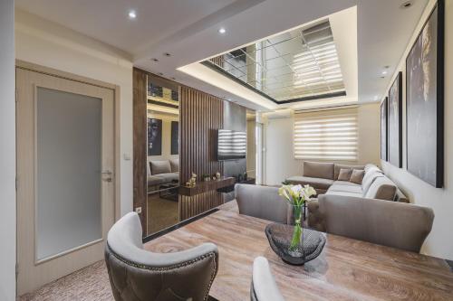 a living room with a table and chairs at Harmony Apartments in Podgorica