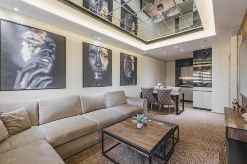 a living room with a couch and a table at Harmony Apartments in Podgorica