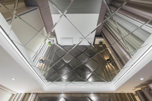 a ceiling in a building with glass at Harmony Apartments in Podgorica
