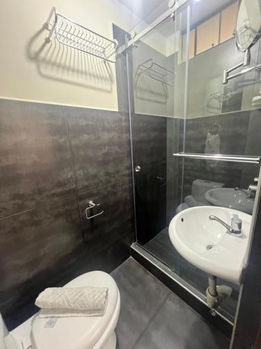 a bathroom with a toilet and a sink at Lima Airport Tampu in Lima