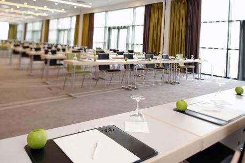 a row of tables and chairs in a room at Atlantic Congress Hotel Essen in Essen
