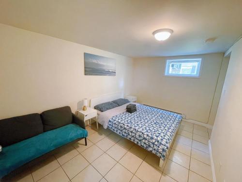 a living room with a couch and a bed at UofC-SAIT-Banff Trail-Suite A&B in Calgary