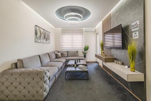 a living room with a couch and a table at Harmony Apartments in Podgorica