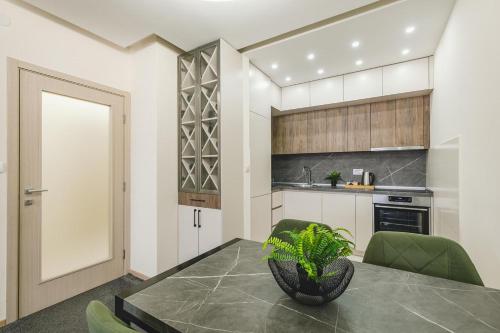 a kitchen with a table with a plant on it at Harmony Apartments in Podgorica