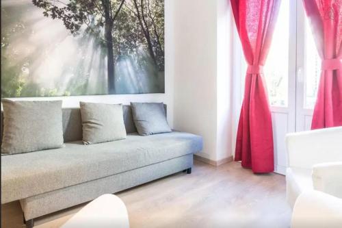a living room with a couch in front of a window at Cool Central Apartment in Brussels