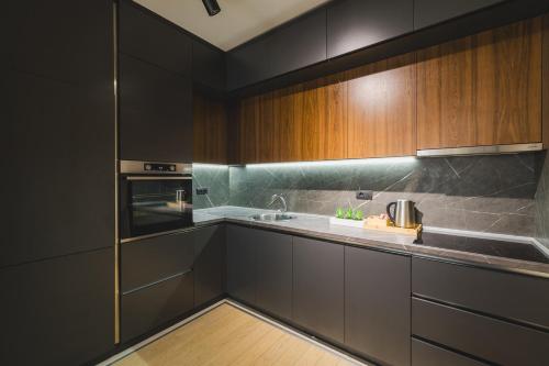a kitchen with wooden cabinets and a sink at Harmony Apartments in Podgorica