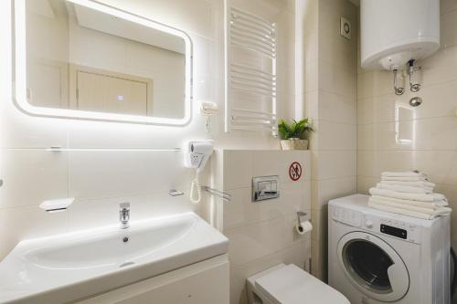 a bathroom with a sink and a washing machine at Harmony Apartments in Podgorica