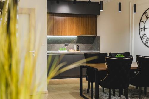 a kitchen and dining room with a table and chairs at Harmony Apartments in Podgorica